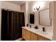Modern bathroom features double vanity sinks, sleek mirrors, and updated lighting at 8500 E Jefferson Ave # 7B, Denver, CO 80237