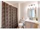 Bathroom with shower/tub combination, decorative curtain, updated lighting, and vanity at 8500 E Jefferson Ave # 7B, Denver, CO 80237