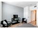 Bedroom featuring gray accent wall, sleek TV console, and easy access to ensuite bathroom at 8500 E Jefferson Ave # 7B, Denver, CO 80237