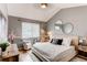 Bedroom features stylish décor, a vaulted ceiling, and two armchairs with a large window at 8500 E Jefferson Ave # 7B, Denver, CO 80237