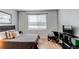 Bedroom features sleek furnishings, neutral colors, and natural light from a large window at 8500 E Jefferson Ave # 7B, Denver, CO 80237