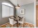 Cozy dining area with a pendant light, seating for four, and a large arched window at 8500 E Jefferson Ave # 7B, Denver, CO 80237