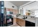 Modern kitchen equipped with stainless steel appliances, a white countertop, and a breakfast bar at 8500 E Jefferson Ave # 7B, Denver, CO 80237