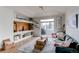 Bright living room with vaulted ceilings, custom built-ins, and sliding glass door to the outdoor patio at 8500 E Jefferson Ave # 7B, Denver, CO 80237