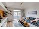 Sunlit living room features modern decor, plush seating, and a sliding glass door to the outside patio at 8500 E Jefferson Ave # 7B, Denver, CO 80237
