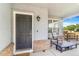 Inviting front porch with comfortable seating, a table, and a secure entry door at 10301 E 112Th Way, Commerce City, CO 80640
