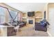 Cozy living room featuring a fireplace, neutral walls, and comfortable seating for relaxation at 10301 E 112Th Way, Commerce City, CO 80640