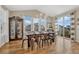 Dining room featuring hardwood floors, large windows with natural light, and modern chandelier at 2896 Setting Sun Ave, Castle Rock, CO 80109