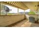 Covered balcony showcases outdoor living space with wood floors, partial views, and an AC unit at 2231 Sable Blvd # 909, Aurora, CO 80011