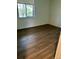 Bedroom showcasing wood floors and natural light from the window at 2231 Sable Blvd # 909, Aurora, CO 80011