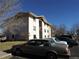 Apartment complex exterior showing parking area and building with neutral siding, visible under a blue sky at 2231 Sable Blvd # 909, Aurora, CO 80011