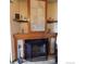 Fireplace with decorative tile surround and wooden mantel with shelves at 2231 Sable Blvd # 909, Aurora, CO 80011