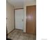 Hallway showing a door and closet with tile floor at 2231 Sable Blvd # 909, Aurora, CO 80011