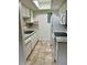 Bright kitchen features white cabinets, tile flooring, and standard appliances for simple home cooking at 2231 Sable Blvd # 909, Aurora, CO 80011