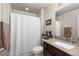 Modern bathroom with a granite sink, white shower curtain and storage shelf at 8104 El Jebel Loop, Castle Rock, CO 80108