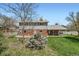 Expansive backyard with a covered patio and play set, perfect for outdoor entertaining and recreation at 11754 W 28Th Ave, Lakewood, CO 80215