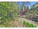 A stream running through a wooded lot is accessible from the back yard via a charming red stairway at 11754 W 28Th Ave, Lakewood, CO 80215