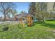 Backyard featuring a large play set with a slide and swings, and a lush lawn for outdoor enjoyment at 11754 W 28Th Ave, Lakewood, CO 80215
