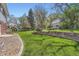 Lush, level backyard with rock border and play area provides a serene and private outdoor space at 11754 W 28Th Ave, Lakewood, CO 80215