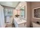 Bathroom with a double vanity, large mirror, and a shower with a white curtain at 11754 W 28Th Ave, Lakewood, CO 80215