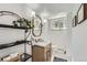 Charming bathroom with a wood vanity, marble countertop, decorative mirror, and patterned tile flooring at 11754 W 28Th Ave, Lakewood, CO 80215