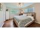 Cozy bedroom with hardwood floors, a ceiling fan, natural lighting and a comfortable patterned quilt at 11754 W 28Th Ave, Lakewood, CO 80215