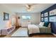 Bright bedroom with hardwood floors, rainbow wall art, and a view from the window at 11754 W 28Th Ave, Lakewood, CO 80215