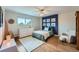 Charming bedroom features hardwood floors, a ceiling fan, and a navy blue accent wall with fun artwork at 11754 W 28Th Ave, Lakewood, CO 80215
