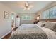 Comfortable bedroom featuring hardwood floors, and a neutral color scheme with access to the bathroom at 11754 W 28Th Ave, Lakewood, CO 80215