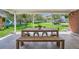Covered patio provides shade for a large table, bench, and chairs overlooking a large, grassy backyard at 11754 W 28Th Ave, Lakewood, CO 80215