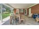 Covered patio with a large table, bench seating, and flagstone flooring overlooks the manicured backyard at 11754 W 28Th Ave, Lakewood, CO 80215