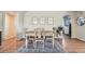 A dining area featuring a wooden table, chairs, decorative rug, and neutral wall art at 11754 W 28Th Ave, Lakewood, CO 80215