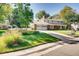Charming two-story home featuring a well-manicured lawn and a long driveway leading to a two-car garage at 11754 W 28Th Ave, Lakewood, CO 80215