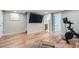 Bright gym with wooden floors, exercise bike, and mounted TV at 11754 W 28Th Ave, Lakewood, CO 80215