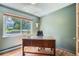 Serene home office with natural light, a modern desk, and wood floors, creating an ideal workspace at 11754 W 28Th Ave, Lakewood, CO 80215