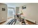 Bright home office with a large window, modern desk, and stylish rug at 11754 W 28Th Ave, Lakewood, CO 80215