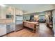 Open concept kitchen with stainless steel appliances and a wooden island connecting to the living room at 11754 W 28Th Ave, Lakewood, CO 80215
