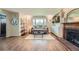 Bright living room with a bay window, fireplace, and built-in shelving with decorative items at 11754 W 28Th Ave, Lakewood, CO 80215