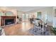 Spacious living area connecting a fireplace, dining space, and access to the backyard at 11754 W 28Th Ave, Lakewood, CO 80215