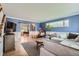 Spacious living room featuring blue walls, hardwood floors, and a cozy seating arrangement with a large sectional at 11754 W 28Th Ave, Lakewood, CO 80215