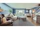 Bright living room with a comfortable sectional sofa, bay window, and hardwood floors with decorative rug at 11754 W 28Th Ave, Lakewood, CO 80215