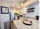 Updated kitchen featuring granite countertops and white cabinets at 4760 S Wadsworth Blvd # H207, Littleton, CO 80123