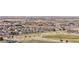 Aerial view of a community highlighting a well-maintained park and nearby commercial areas at 9758 Laredo St # 18D, Commerce City, CO 80022