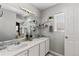 Bright bathroom featuring a double vanity, and modern lighting at 9758 Laredo St # 18D, Commerce City, CO 80022