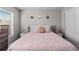 Bedroom features neutral paint, windows, chandelier, and a queen size bed with decorative pillows at 9758 Laredo St # 18D, Commerce City, CO 80022