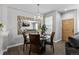 Dining area with a round table, wooden chairs, large mirror, and an elegant light fixture at 9758 Laredo St # 18D, Commerce City, CO 80022