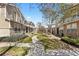 View of manicured front yard with sidewalks and exteriors of townhomes at 9758 Laredo St # 18D, Commerce City, CO 80022