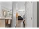 Hallway featuring wood flooring, access to the kitchen and stairs, and a view of the living area at 9758 Laredo St # 18D, Commerce City, CO 80022