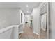 Hallway features neutral paint, carpet, recessed lighting, table with flowers, and large mirror at 9758 Laredo St # 18D, Commerce City, CO 80022