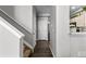 Hallway features hardwood floors and neutral decor, connecting to the kitchen and other living areas at 9758 Laredo St # 18D, Commerce City, CO 80022